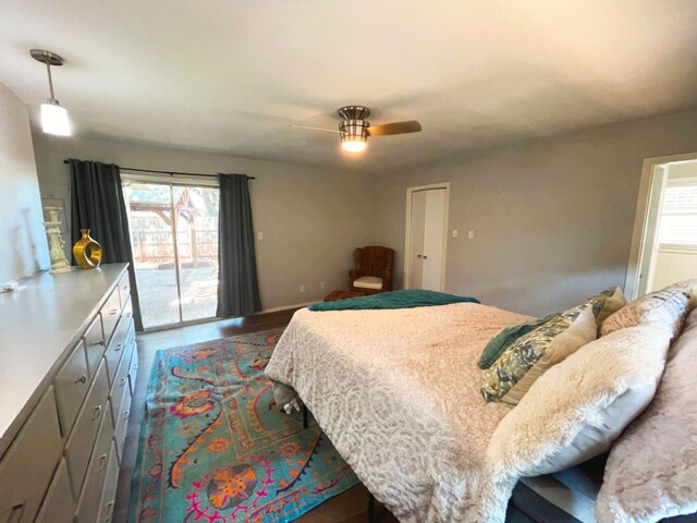 bedroom with hardwood / wood-style flooring, access to outside, and ceiling fan