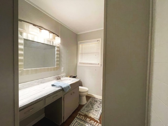 bathroom featuring vanity, ornamental molding, and toilet