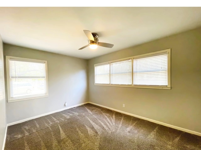 carpeted spare room with ceiling fan