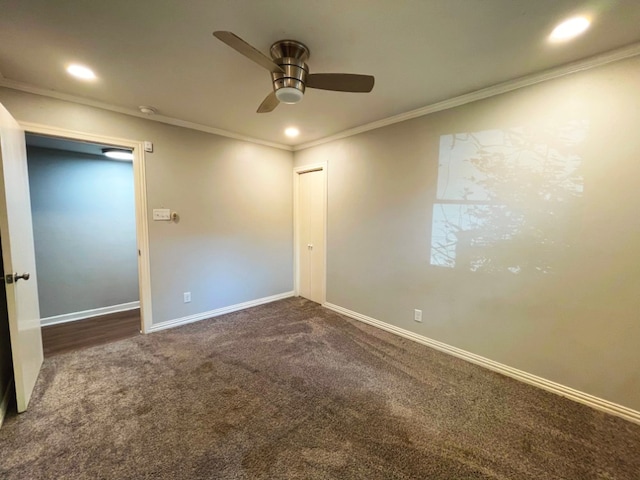 carpeted spare room with crown molding and ceiling fan