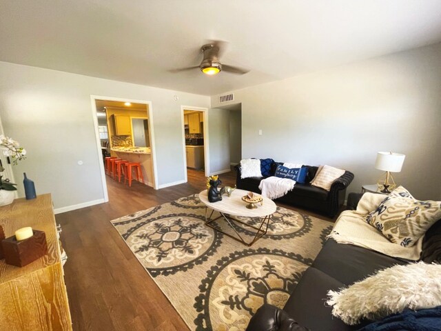 living room featuring dark hardwood / wood-style floors and ceiling fan