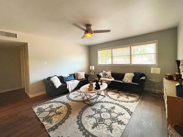 living room featuring ceiling fan and dark hardwood / wood-style flooring