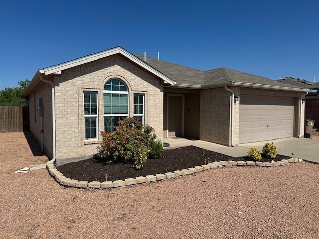1227 Elmo Ln, San Angelo, TX 76905 - ranch-style house featuring an attached garage, brick siding, and concrete driveway
