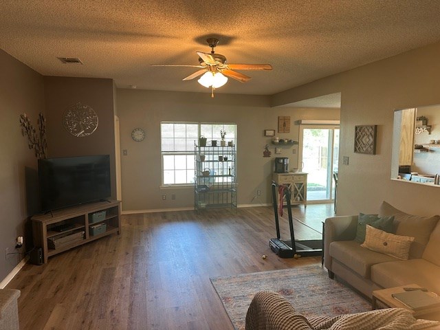 1227 Elmo Ln, San Angelo, TX 76905 - living room featuring a ceiling fan, wood finished floors, and a textured ceiling