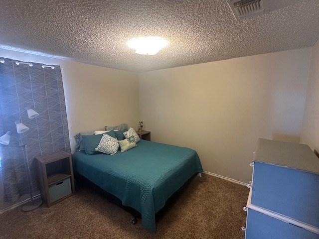 1227 Elmo Ln, San Angelo, TX 76905 - carpeted bedroom with a textured ceiling