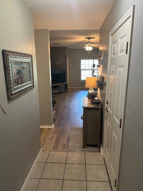 1227 Elmo Ln, San Angelo, TX 76905 - corridor with a textured ceiling and light tile patterned floors