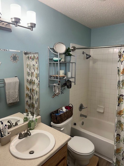 1227 Elmo Ln, San Angelo, TX 76905 - full bathroom with a textured ceiling, vanity, and shower / tub combo