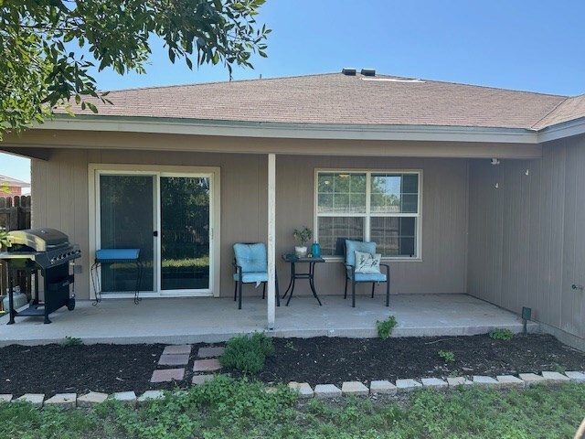1227 Elmo Ln, San Angelo, TX 76905 - back of property featuring a patio area, a porch, and roof with shingles