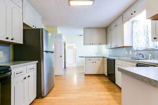 kitchen with white cabinetry, dishwasher, electric range, and light wood-type flooring