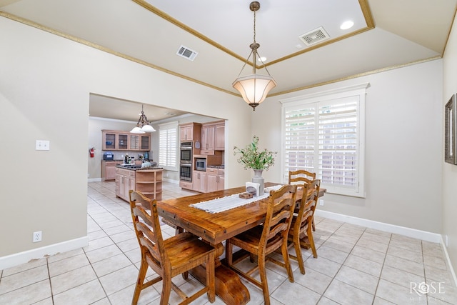 tiled dining room with crown molding and a wealth of natural light