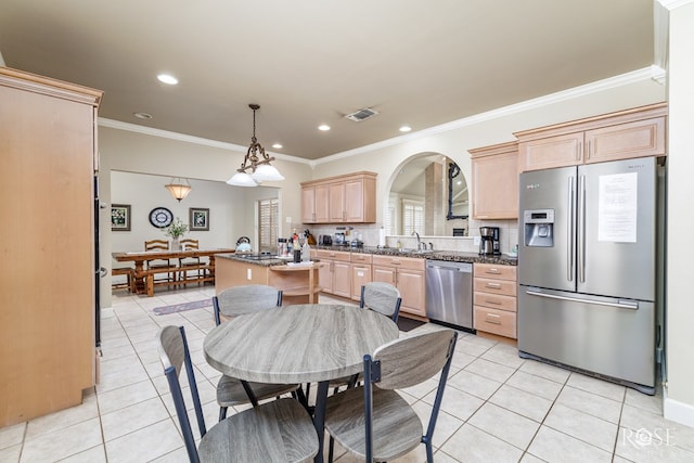 kitchen featuring light brown cabinetry, light tile patterned floors, dark stone countertops, and appliances with stainless steel finishes