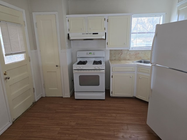 kitchen featuring sink, white cabinetry, dark hardwood / wood-style flooring, white appliances, and decorative backsplash