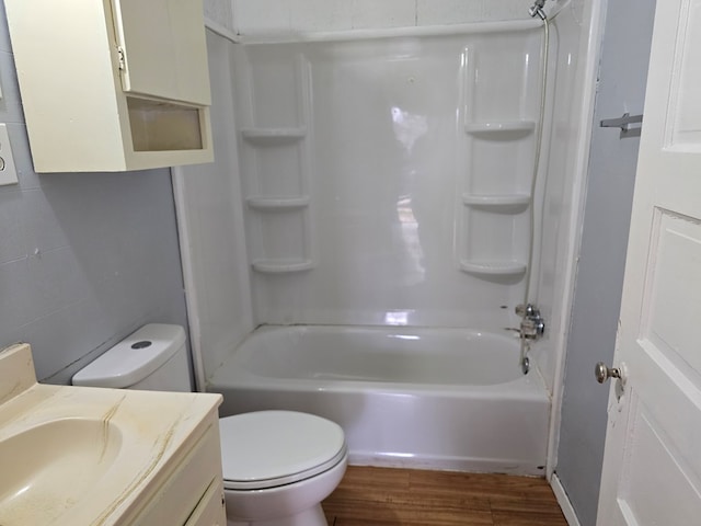 full bathroom with vanity, hardwood / wood-style flooring, bathing tub / shower combination, and toilet