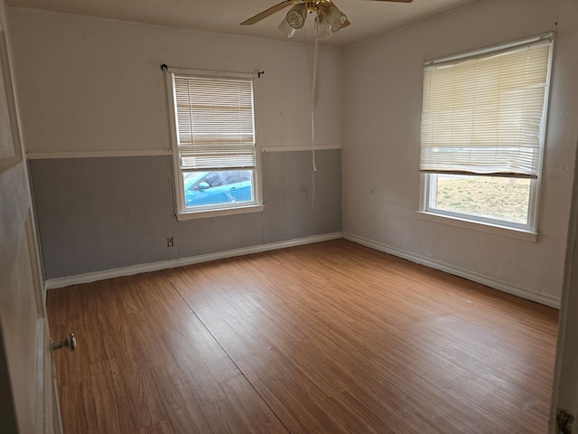 empty room featuring light hardwood / wood-style flooring, plenty of natural light, and ceiling fan