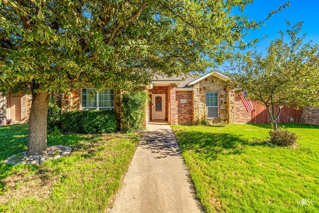 4122 Harmony Ln, San Angelo, TX 76904 - view of property hidden behind natural elements featuring a front yard, brick siding, and stone siding