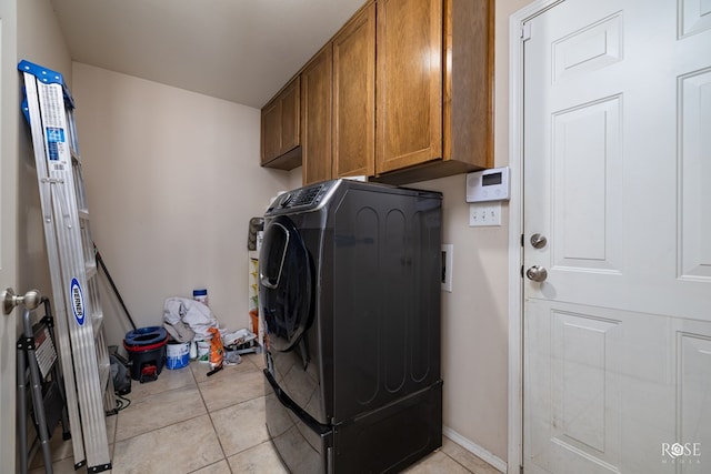4122 Harmony Ln, San Angelo, TX 76904 - laundry area with washer / dryer, cabinet space, and light tile patterned flooring