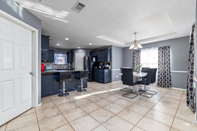 4122 Harmony Ln, San Angelo, TX 76904 - dining room featuring a chandelier, light tile patterned floors, a raised ceiling, and recessed lighting