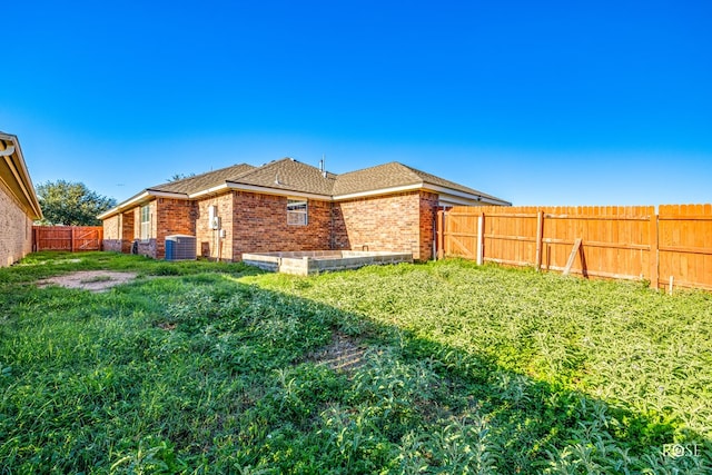 4122 Harmony Ln, San Angelo, TX 76904 - back of house with brick siding, a fenced backyard, and a shingled roof