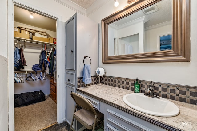 bathroom with vanity, backsplash, and ornamental molding