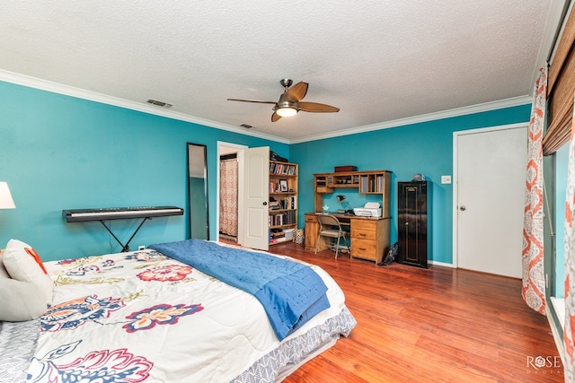 bedroom with ceiling fan, crown molding, wood-type flooring, and a textured ceiling