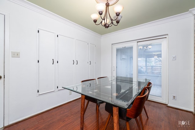 dining area with ornamental molding, dark hardwood / wood-style floors, and a chandelier