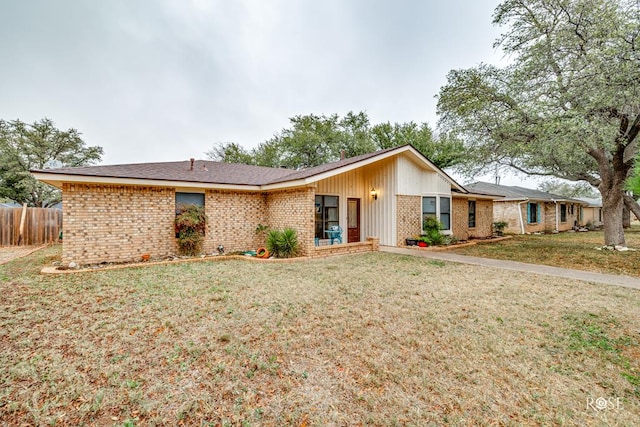 ranch-style home featuring a front yard