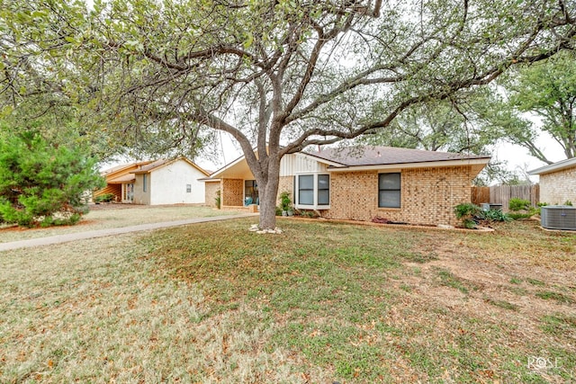 single story home with a front lawn and central air condition unit