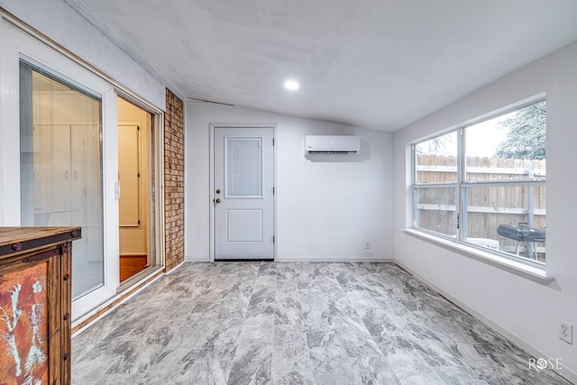 empty room featuring vaulted ceiling and a wall unit AC