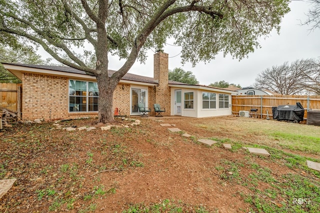 rear view of property featuring a yard