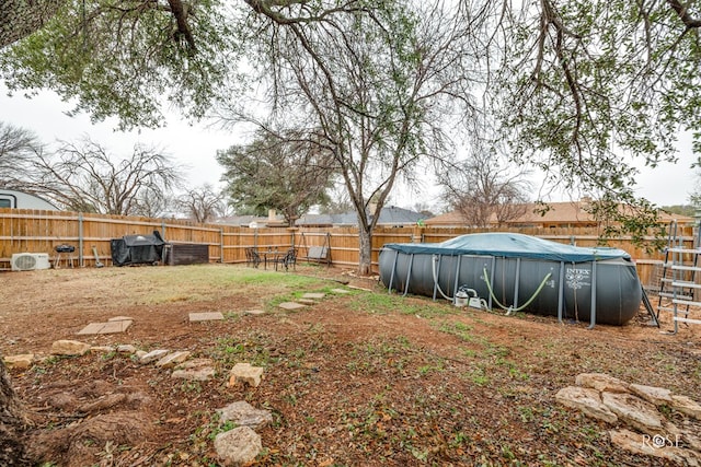 view of yard featuring a covered pool