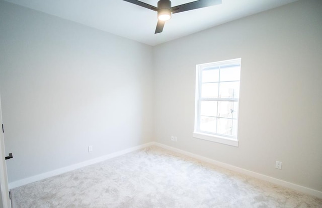 empty room featuring carpet floors, ceiling fan, and baseboards