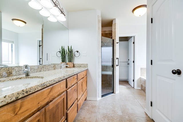 1113 Windemere Cir, San Angelo, TX 76901 - bathroom with a stall shower, double vanity, tile patterned floors, and baseboards