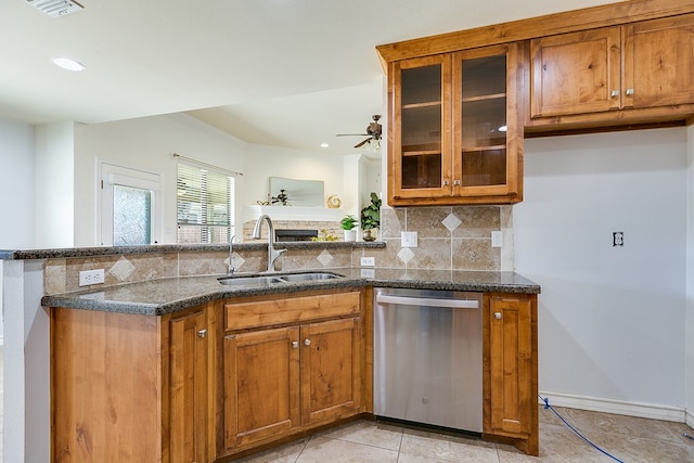 1113 Windemere Cir, San Angelo, TX 76901 - kitchen featuring stainless steel dishwasher, a sink, brown cabinetry, a ceiling fan, and a peninsula