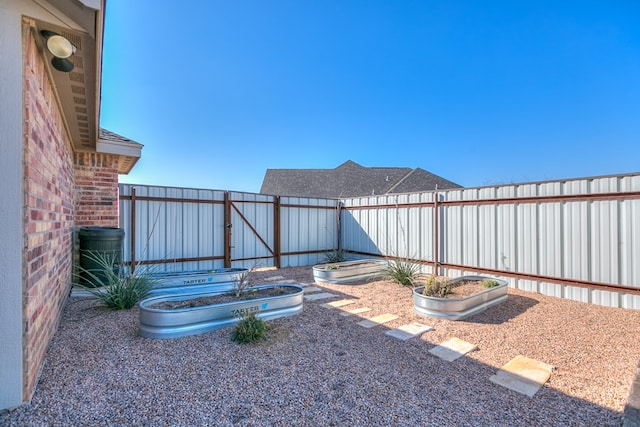 view of yard featuring a garden and a fenced backyard