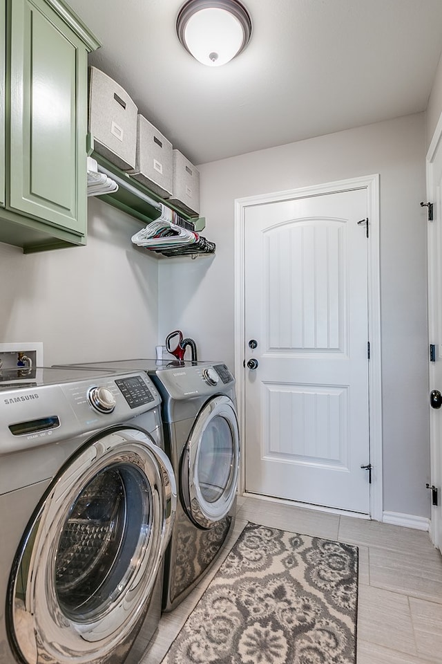 washroom featuring cabinet space, light tile patterned floors, and separate washer and dryer