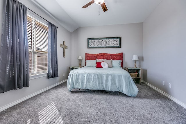 carpeted bedroom with vaulted ceiling, baseboards, and ceiling fan