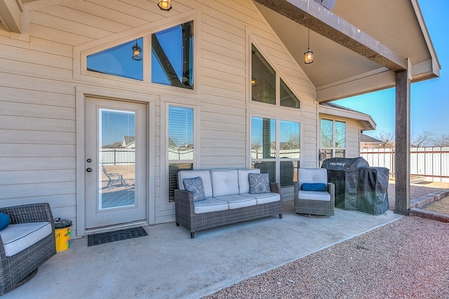 view of patio with area for grilling, fence, and an outdoor hangout area