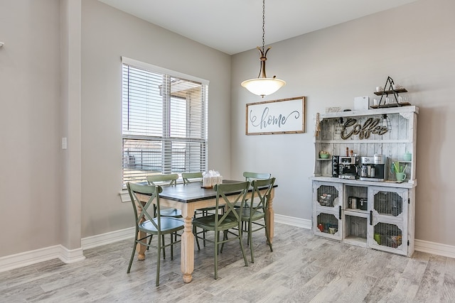 dining area featuring wood finished floors and baseboards