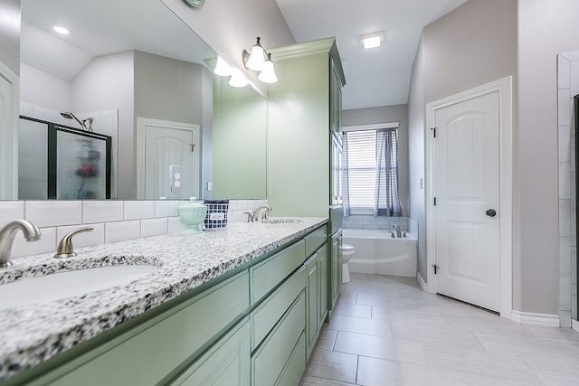 full bath featuring a sink, a garden tub, double vanity, and a shower stall