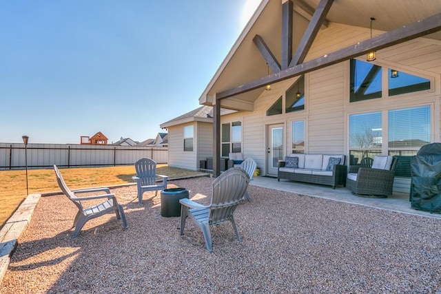 view of patio / terrace featuring an outdoor living space with a fire pit and fence