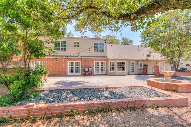 2622 Oxford Ave, San Angelo, TX 76904 - rear view of house featuring french doors, a patio area, and brick siding