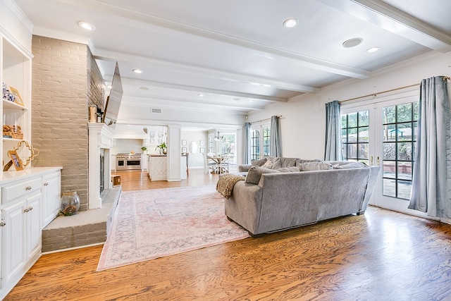 2622 Oxford Ave, San Angelo, TX 76904 - living room featuring plenty of natural light, light wood finished floors, beamed ceiling, a fireplace, and recessed lighting
