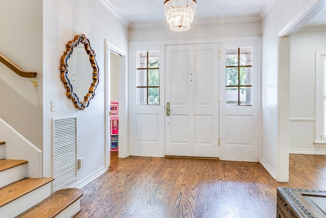 2622 Oxford Ave, San Angelo, TX 76904 - entryway featuring stairs, wood finished floors, healthy amount of natural light, a chandelier, and crown molding