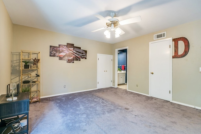 2622 Oxford Ave, San Angelo, TX 76904 - unfurnished bedroom featuring carpet flooring, baseboards, ceiling fan, and ensuite bath