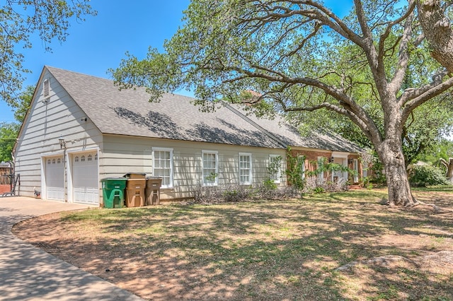 2622 Oxford Ave, San Angelo, TX 76904 - view of property exterior with a garage, a shingled roof, and driveway
