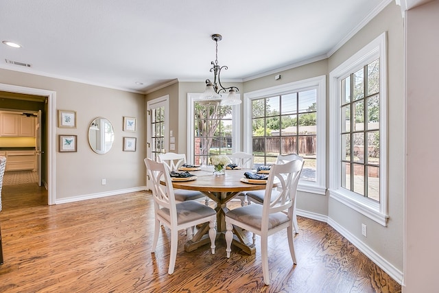 2622 Oxford Ave, San Angelo, TX 76904 - dining area with light wood-style floors, baseboards, crown molding, recessed lighting, and a chandelier