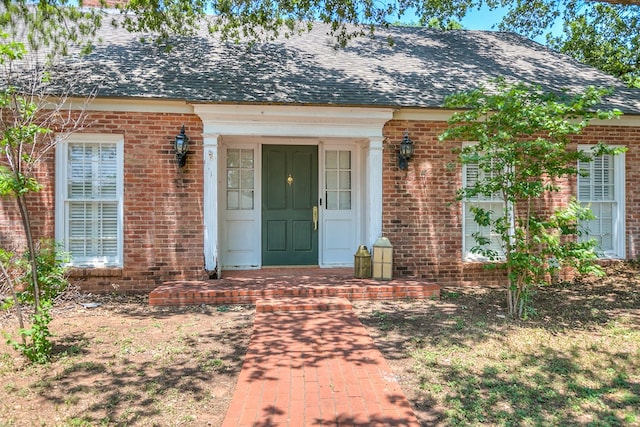2622 Oxford Ave, San Angelo, TX 76904 - view of exterior entry featuring brick siding and roof with shingles