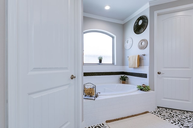 bathroom featuring a relaxing tiled tub, crown molding, and tile patterned floors