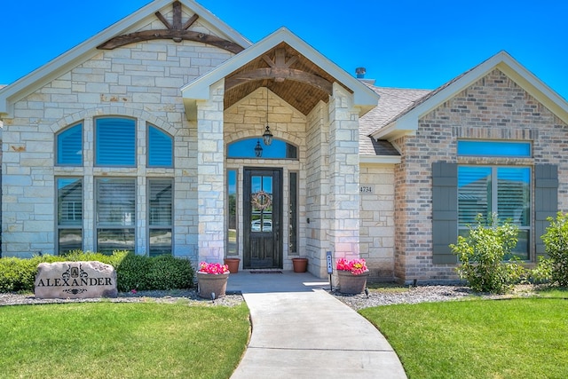 doorway to property with a lawn