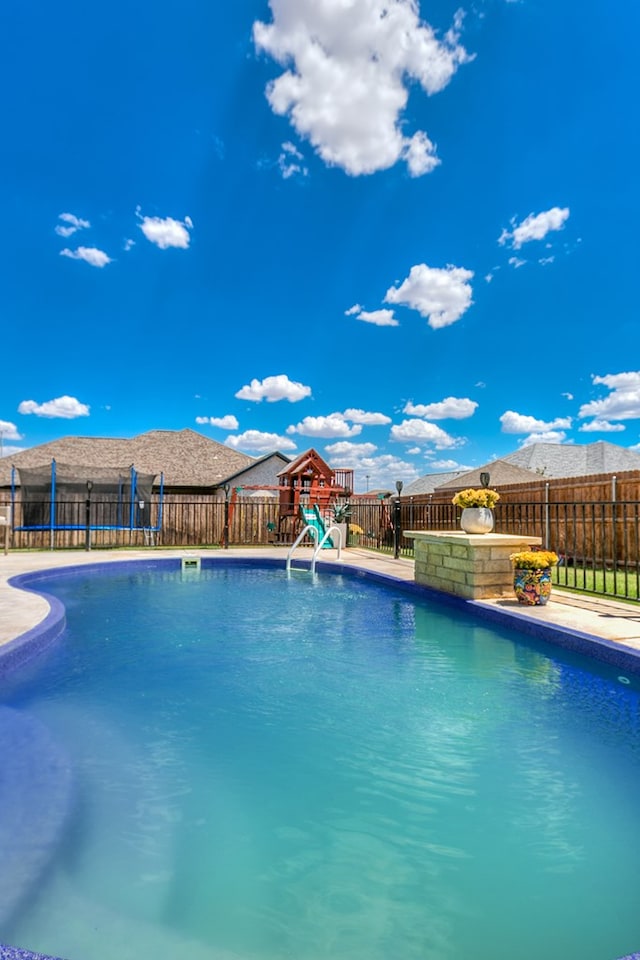 view of pool featuring a playground